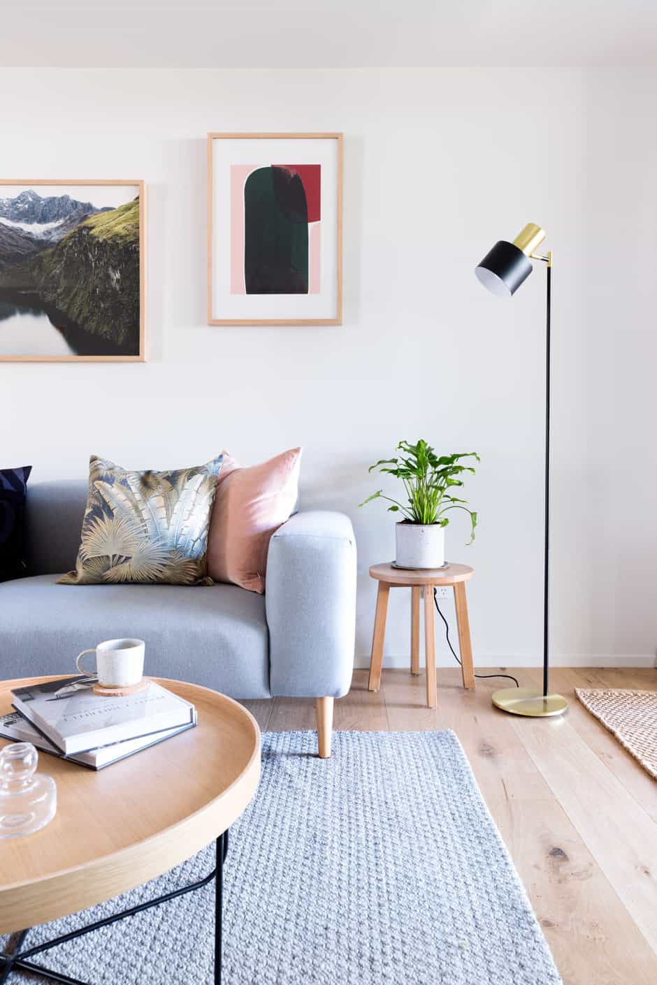 LIVING Photographic artwork South (left) by Brooke Holm and No 14 by Berit Mogensen Lopez hang above a sofa and coffee table from Città. The floor lamp is from Lighting Direct, and the Sherpa Weave rug by Armadillo & Co is from The Ivy House.