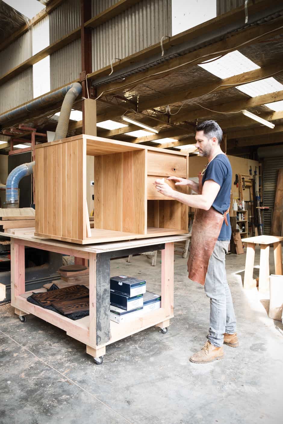 MEN AT WORK Will and Faustin get down to business. Wherever possible, the bespoke pieces they make are crafted from recycled and sustainably sourced timber, which is often customised with other materials including steel, copper and leather.